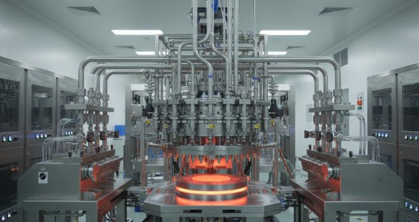 Industrial MOCVD reactor with glowing orange heated susceptor and stainless steel gas delivery system
