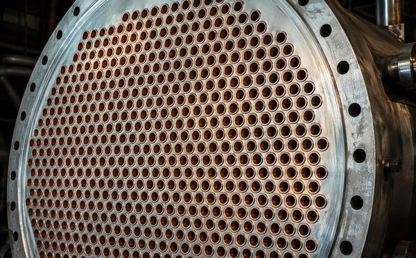 Circular tube sheet of a copper-nickel heat exchanger with hundreds of tube ends