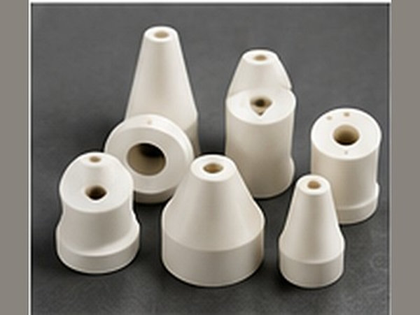 A group of tapered ceramic nozzles and small shaped fittings.