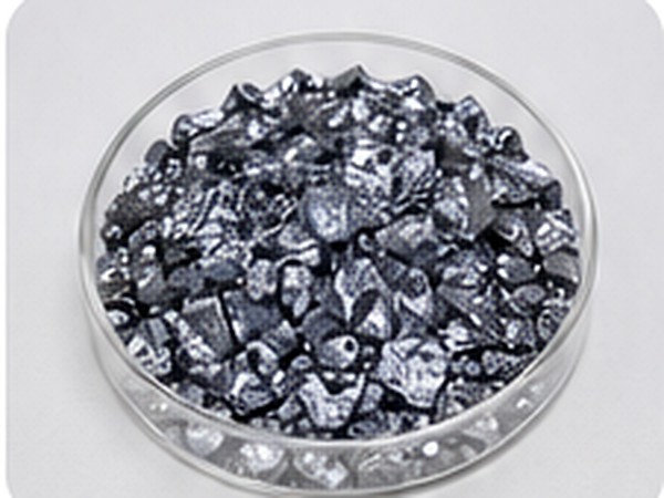 Reflective sized polysilicon pieces arranged in a clean circular laboratory dish.