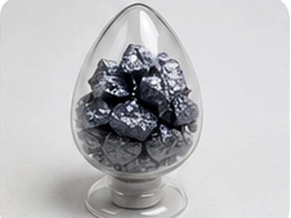 High-purity silicon chunks enclosed in a clear laboratory display vessel.