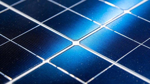 Close-up view of blue silicon solar photovoltaic cells with oxide-based anti-reflective thin film coatings