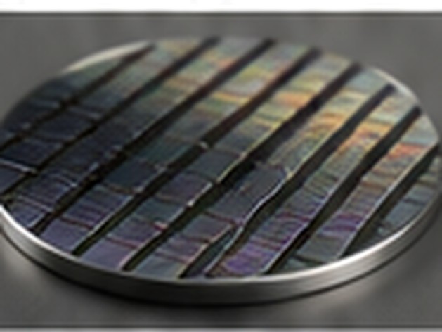 Iridescent patterned semiconductor wafer illustrating deposited metal and multilayer thin films.