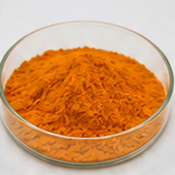 Fine orange organic material is arranged as a uniform powder sample in a shallow dish.